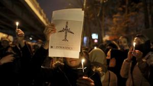 FILE - In this Jan. 11, 2020, file photo, people gather for a candlelight vigil to remember the victims of the Ukraine plane crash at the gate of Amri Kabir University in Tehran, Iran.(AP) FILE - In this Jan. 11, 2020, file photo, people gather for a candlelight vigil to remember the victims of the Ukraine plane crash at the gate of Amri Kabir University in Tehran, Iran.(AP)