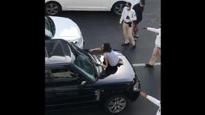 The woman, who reportedly suspected that her husband was having an affair, obstructed the Range Rover, got out of her vehicle and yelled at her husband to come out. She also climbed on the bonnet of the vehicle.(Screengrab) The woman, who reportedly suspected that her husband was having an affair, obstructed the Range Rover, got out of her vehicle and yelled at her husband to come out. She also climbed on the bonnet of the vehicle.(Screengrab)