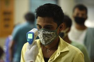 A health worker uses an infrared thermometer thermal screen a man during swab sample collection for coronavirus testing at Sukhrali Enclave near Shiv temple, in Gurugram on Sunday.(Parveen Kumar/HT File Photo) A health worker uses an infrared thermometer thermal screen a man during swab sample collection for coronavirus testing at Sukhrali Enclave near Shiv temple, in Gurugram on Sunday.(Parveen Kumar/HT File Photo)