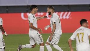 Real Madrid's Karim Benzema, right, celebrates after scoring a penalty against Deportivo Alaves with his teammate Marco Asensio during the Spanish La Liga soccer match between Real Madrid and Deportivo Alaves at the Alfredo di Stefano stadium in Madrid, Spain, Friday, July 10, 2020.(AP) Real Madrid's Karim Benzema, right, celebrates after scoring a penalty against Deportivo Alaves with his teammate Marco Asensio during the Spanish La Liga soccer match between Real Madrid and Deportivo Alaves at the Alfredo di Stefano stadium in Madrid, Spain, Friday, July 10, 2020.(AP)