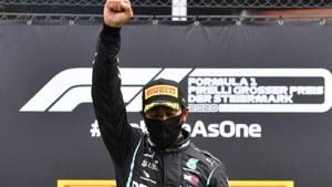 Mercedes' Lewis Hamilton wears a protective face mask as he celebrates winning the race on the podium.(REUTERS) Mercedes' Lewis Hamilton wears a protective face mask as he celebrates winning the race on the podium.(REUTERS)