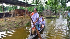 Villagers cross a flooded area on a boat at Bagmari village near Kaziranga in Nagaon district on Monday.(PTI Photo) Villagers cross a flooded area on a boat at Bagmari village near Kaziranga in Nagaon district on Monday.(PTI Photo)