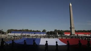 Soldiers hold a French flag during a rehearsal for the Bastille Day parade on the Concorde square in Paris Monday, July 13, 2020. (AP Photo/Christophe Ena) Soldiers hold a French flag during a rehearsal for the Bastille Day parade on the Concorde square in Paris Monday, July 13, 2020. (AP Photo/Christophe Ena)