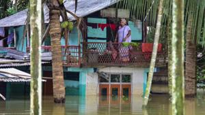 Nagaon: A woman marooned in her house in the flood-hit Baghmari village in Nagaon district of Assam.(PTI)
