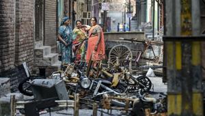 Women stand beside charred remains of vehicles and vandalised properties at Shiv Vihar in northeast Delhi on March 2, 2020.(PTI File Photo) Women stand beside charred remains of vehicles and vandalised properties at Shiv Vihar in northeast Delhi on March 2, 2020.(PTI File Photo)