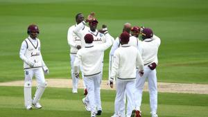 Jason Holder and Roston Chase celebrate the wicket of Zak Crawley of England with teammates during Day One of the 2nd Test Match in the #RaiseTheBat Series between England and The West Indies at Emirates Old Trafford on July 16, 2020 in Manchester, England.(Getty Images for ECB) Jason Holder and Roston Chase celebrate the wicket of Zak Crawley of England with teammates during Day One of the 2nd Test Match in the #RaiseTheBat Series between England and The West Indies at Emirates Old Trafford on July 16, 2020 in Manchester, England.(Getty Images for ECB)