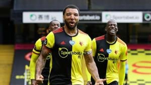 FILE PHOTO: Soccer Football - Premier League - Watford v Newcastle United - Vicarage Road, Watford, Britain - July 11, 2020 Watford's Troy Deeney celebrates scoring their second goal from the penalty spot, as play resumes behind closed doors following the outbreak of the coronavirus disease (COVID-19)/File Photo(Pool via REUTERS) FILE PHOTO: Soccer Football - Premier League - Watford v Newcastle United - Vicarage Road, Watford, Britain - July 11, 2020 Watford's Troy Deeney celebrates scoring their second goal from the penalty spot, as play resumes behind closed doors following the outbreak of the coronavirus disease (COVID-19)/File Photo(Pool via REUTERS)