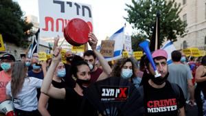 People protest against Israeli Prime Minister Benjamin Netanyahu and his government's response to the financial fallout of the coronavirus disease crisis outside Prime Minister Benjamin Netanyahu's residence in Jerusalem.(REUTERS) People protest against Israeli Prime Minister Benjamin Netanyahu and his government's response to the financial fallout of the coronavirus disease crisis outside Prime Minister Benjamin Netanyahu's residence in Jerusalem.(REUTERS)