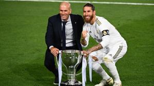 Real Madrid's French coach Zinedine Zidane and Real Madrid's Spanish defender Sergio Ramos celebrate with the trophy after winning the Liga title after the Spanish League football match between Real Madrid CF and Villarreal CF at the Alfredo di Stefano stadium in Valdebebas, on the outskirts of Madrid, on July 16, 2020.(AFP) Real Madrid's French coach Zinedine Zidane and Real Madrid's Spanish defender Sergio Ramos celebrate with the trophy after winning the Liga title after the Spanish League football match between Real Madrid CF and Villarreal CF at the Alfredo di Stefano stadium in Valdebebas, on the outskirts of Madrid, on July 16, 2020.(AFP)