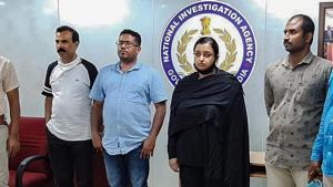 Kerala gold smuggling case accused Swapna Suresh and Sandeep Nair (both in middle) after they were arrested by the National Investigation Agency in Bengaluru, Karnataka on Saturday.(PTI Photo) Kerala gold smuggling case accused Swapna Suresh and Sandeep Nair (both in middle) after they were arrested by the National Investigation Agency in Bengaluru, Karnataka on Saturday.(PTI Photo)