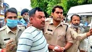Police personnel were bringing Vikas Dubey back from Ujjain, where he was arrested while on the run from the UP police.(ANI Photo) Police personnel were bringing Vikas Dubey back from Ujjain, where he was arrested while on the run from the UP police.(ANI Photo)