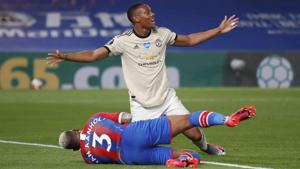 Manchester United's Anthony Martial celebrates scoring their second goal as Crystal Palace's Patrick van Aanholt lies injured.(Pool/REUTERS) Manchester United's Anthony Martial celebrates scoring their second goal as Crystal Palace's Patrick van Aanholt lies injured.(Pool/REUTERS)