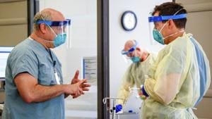 Dr. Michael Saag, left, speaks with an unidentified coworker in Birmingham on July 10, 2020. Saag survived Covid-19 and now treats patients with the disease.(AP) Dr. Michael Saag, left, speaks with an unidentified coworker in Birmingham on July 10, 2020. Saag survived Covid-19 and now treats patients with the disease.(AP)