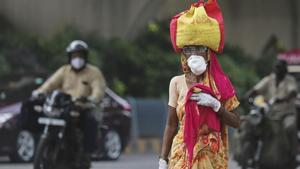 A woman wearing a face mask walks on a street in Hyderabad. India crossed 1 million coronavirus cases on Friday, third only to the United States and Brazil, prompting concerns about its readiness to confront an inevitable surge that could overwhelm hospitals and test the country's feeble health care system.(AP) A woman wearing a face mask walks on a street in Hyderabad. India crossed 1 million coronavirus cases on Friday, third only to the United States and Brazil, prompting concerns about its readiness to confront an inevitable surge that could overwhelm hospitals and test the country's feeble health care system.(AP)