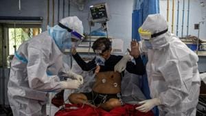 Medical workers wearing personal protective equipment (PPE) tend to a patient suffering from the coronavirus disease (Covid-19), in the Intensive Care Unit (ICU) at Lok Nayak Jai Prakash (LNJP) hospital, in New Delhi.(REUTERS) Medical workers wearing personal protective equipment (PPE) tend to a patient suffering from the coronavirus disease (Covid-19), in the Intensive Care Unit (ICU) at Lok Nayak Jai Prakash (LNJP) hospital, in New Delhi.(REUTERS)
