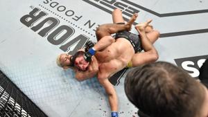 Deiveson Figueiredo of Brazil secures a rear choke submission against Joseph Benavidez in their UFC flyweight championship bout during UFC Fight Night at the Flash Forum on UFC Fight Island.(USA TODAY Sports) Deiveson Figueiredo of Brazil secures a rear choke submission against Joseph Benavidez in their UFC flyweight championship bout during UFC Fight Night at the Flash Forum on UFC Fight Island.(USA TODAY Sports)
