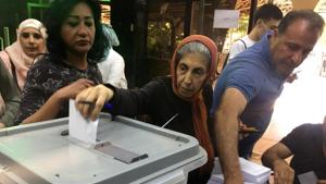 A woman casts her vote inside a polling station during the parliamentary elections in Damascus, Syria on July 19, 2020.(Reuters Photo) A woman casts her vote inside a polling station during the parliamentary elections in Damascus, Syria on July 19, 2020.(Reuters Photo)
