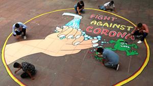 NSS volunteers from the Social Work Department paint graffiti to spread awareness about Coronavirus at the Student Centre in Panjab University, Chandigarh. (Photo by Keshav Singh/Hindustan Times) NSS volunteers from the Social Work Department paint graffiti to spread awareness about Coronavirus at the Student Centre in Panjab University, Chandigarh. (Photo by Keshav Singh/Hindustan Times)