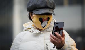 A woman looks at her mobile phone, Beijing, 2020. China’s digital surge has not only reinvented the economy, but has also bolstered the nation’s growth rate.(AFP) A woman looks at her mobile phone, Beijing, 2020. China’s digital surge has not only reinvented the economy, but has also bolstered the nation’s growth rate.(AFP)