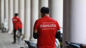 A delivery worker of Zomato, an Indian food-delivery startup, waits to collect an order from a restaurant, during an extended nationwide lockdown to slow the spread of the coronavirus disease (Covid-19), in New Delhi.(MAR) A delivery worker of Zomato, an Indian food-delivery startup, waits to collect an order from a restaurant, during an extended nationwide lockdown to slow the spread of the coronavirus disease (Covid-19), in New Delhi.(MAR)