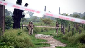 Policemen stand near a taped off area following the killing of Vikas Dubey, accused of ordering the killing of eight policemen, near Kanpur.(REUTERS)