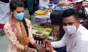 Mehendi artists are taking all the necessary precautions while attending customers who are keen to get henna tattoos on Teej. Mehendi artists are taking all the necessary precautions while attending customers who are keen to get henna tattoos on Teej.