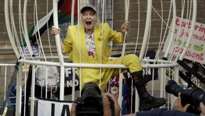 Fashion designer Vivienne Westwood stands in a giant bird cage in protest against the extradition of WikiLeaks founder Julian Assange to the U.S., outside the Old Bailey court, in London.(AP Photo/Matt Dunham) Fashion designer Vivienne Westwood stands in a giant bird cage in protest against the extradition of WikiLeaks founder Julian Assange to the U.S., outside the Old Bailey court, in London.(AP Photo/Matt Dunham)
