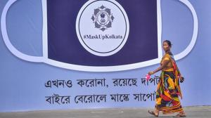 A woman walks past a billboard, set up by police to spread awareness on preventive measures against Covid-19, in Kolkata.(PTI) A woman walks past a billboard, set up by police to spread awareness on preventive measures against Covid-19, in Kolkata.(PTI)