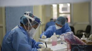 Medics in PPE suits complete paperwork at a coronavirus test desk at Delhi’s Lok Nayak jai Prakash (LNJP) Hospital.(Vipin Kumar/HT PHOTO) Medics in PPE suits complete paperwork at a coronavirus test desk at Delhi’s Lok Nayak jai Prakash (LNJP) Hospital.(Vipin Kumar/HT PHOTO)