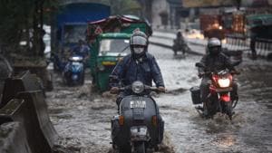 Commuters make their way past heavy water logging after a spell of rain at Anand Parbat, in New Delhi.(Sanchit Khanna/HT PHOTO) Commuters make their way past heavy water logging after a spell of rain at Anand Parbat, in New Delhi.(Sanchit Khanna/HT PHOTO)