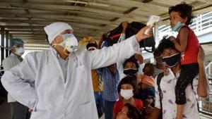 File photo: Migrants arriving from Surat in Gujarat undergo thermal screening as they exit Prayagraj Railway Station.(PTI) File photo: Migrants arriving from Surat in Gujarat undergo thermal screening as they exit Prayagraj Railway Station.(PTI)