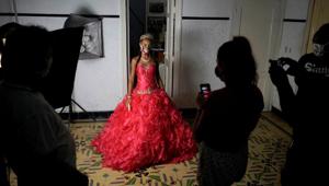 Naomi Ramos poses as she tries dresses for her quinceanera (coming of age of 15-year-olds) celebration amid coronavirus disease (Covid-19) spread concerns, in Havana, Cuba. (REUTERS/Alexandre Meneghini) Naomi Ramos poses as she tries dresses for her quinceanera (coming of age of 15-year-olds) celebration amid coronavirus disease (Covid-19) spread concerns, in Havana, Cuba. (REUTERS/Alexandre Meneghini)