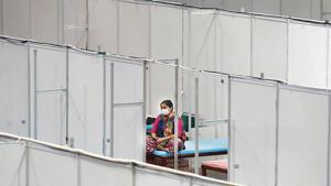 A woman sits on her bed inside a care centre for the coronavirus disease patients at an indoor sports complex in New Delhi.(Reuters) A woman sits on her bed inside a care centre for the coronavirus disease patients at an indoor sports complex in New Delhi.(Reuters)