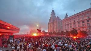 Liverpool fans let off flares outside the Liver Building in Liverpool, Friday June 26, 2020, as Liverpool soccer fans gather and celebrate for the team clinched the English Premier League title.(AP) Liverpool fans let off flares outside the Liver Building in Liverpool, Friday June 26, 2020, as Liverpool soccer fans gather and celebrate for the team clinched the English Premier League title.(AP)