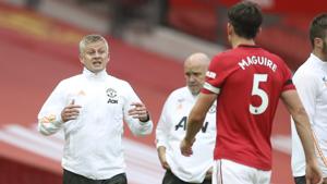 Manchester United's manager Ole Gunnar Solskjaer talks to Manchester United's Harry Maguire during the English Premier League soccer match between Manchester United and West Ham at the Old Trafford stadium in Manchester, England, Wednesday, July 22, 2020. (Martin Rickett/Pool via AP)(AP) Manchester United's manager Ole Gunnar Solskjaer talks to Manchester United's Harry Maguire during the English Premier League soccer match between Manchester United and West Ham at the Old Trafford stadium in Manchester, England, Wednesday, July 22, 2020. (Martin Rickett/Pool via AP)(AP)