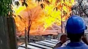Employees record an explosion which occurred near Oil India Limited’s gas well, at Baghjan in Assam’s Tinsukia district, on Wednesday.(PTI Photo) Employees record an explosion which occurred near Oil India Limited’s gas well, at Baghjan in Assam’s Tinsukia district, on Wednesday.(PTI Photo)