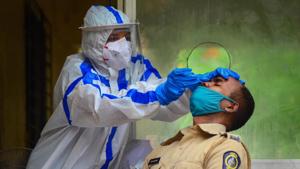 Panvel City Municipal Corporation doctor collects swab sample of a policeman for Rapid Antigen Test, in Navi Mumbai on Thursday.(PTI Photo) Panvel City Municipal Corporation doctor collects swab sample of a policeman for Rapid Antigen Test, in Navi Mumbai on Thursday.(PTI Photo)