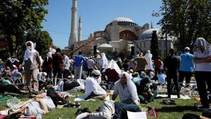 People wait for the beginning of Friday prayers outside Hagia Sophia Grand Mosque, for the first time after it was once again declared a mosque after 86 years in Istanbul, Turkey.(Reuters Photo)