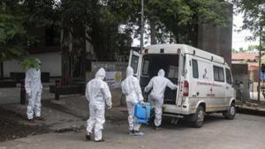 Contract workers in PPE equipment seen sanitizing the ambulance after transporting the body of a coronavirus victim, at Yerwada crematorium, in Pune.(Pratham Gokhale/HT Photo) Contract workers in PPE equipment seen sanitizing the ambulance after transporting the body of a coronavirus victim, at Yerwada crematorium, in Pune.(Pratham Gokhale/HT Photo)