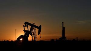 A pump jack operates in front of a drilling rig at sunset in an oil field in Midland, Texas US(Reuters File Photo) A pump jack operates in front of a drilling rig at sunset in an oil field in Midland, Texas US(Reuters File Photo)