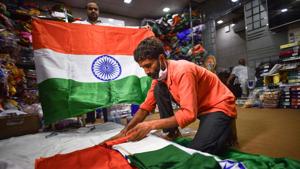 A person at a shop selling flags folds up a national tricolour at Sadar Bazar in New Delhi.(Sanchit Khanna/HT PHOTO) A person at a shop selling flags folds up a national tricolour at Sadar Bazar in New Delhi.(Sanchit Khanna/HT PHOTO)