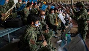Members of the Philippine National Police wearing masks for protection against the coronavirus disease (COVID-19), play music inside a baseball stadium where thousands of stranded Filipinos wait to be transported back to their provinces through a government transportation program, in Rizal Memorial Sports Complex.(REUTERS) Members of the Philippine National Police wearing masks for protection against the coronavirus disease (COVID-19), play music inside a baseball stadium where thousands of stranded Filipinos wait to be transported back to their provinces through a government transportation program, in Rizal Memorial Sports Complex.(REUTERS)