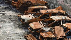 A man walks past the charred remains of vehicles set ablaze by rioters at parking during the anti-CAA protests in February, at Shiv Vihar area of Northeast Delhi.(PTI) A man walks past the charred remains of vehicles set ablaze by rioters at parking during the anti-CAA protests in February, at Shiv Vihar area of Northeast Delhi.(PTI)