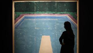 A woman looks at a painting by David Hockney called 'Pool on a Cloudy Day with Rain (Paper Pool 22)' at Sotheby's auction rooms in London, Thursday, July 23, 2020. The painting estimated at 4-6 million UK Pounds (5.10-7.65 million US Dollars) will go on sale in the 'Rembrandt to Richter' evening sale on July 28. (AP Photo/Kirsty Wigglesworth) A woman looks at a painting by David Hockney called 'Pool on a Cloudy Day with Rain (Paper Pool 22)' at Sotheby's auction rooms in London, Thursday, July 23, 2020. The painting estimated at 4-6 million UK Pounds (5.10-7.65 million US Dollars) will go on sale in the 'Rembrandt to Richter' evening sale on July 28. (AP Photo/Kirsty Wigglesworth)