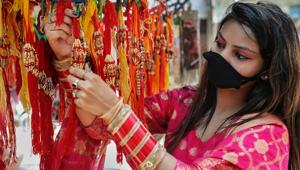 Jammu: A young woman purchases 'rakhi' ahead of Raksha Bandhan festival, in Jammu, Wednesday, July 22, 2020.(PTI)