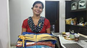 Shobha, a karigar with newly stitched bags from used bedsheets Shobha, a karigar with newly stitched bags from used bedsheets
