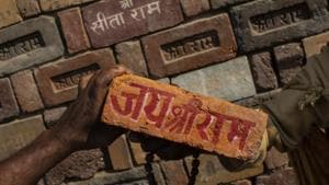 A man holds a brick reading A man holds a brick reading
