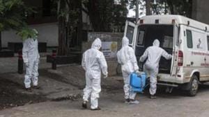Contract workers in PPE equipment seen sanitizing the ambulance after transporting the body of a coronavirus victim, at Yerwada crematorium, in Pune, Maharashtra.(Pratham Gokhale/HT Photo) Contract workers in PPE equipment seen sanitizing the ambulance after transporting the body of a coronavirus victim, at Yerwada crematorium, in Pune, Maharashtra.(Pratham Gokhale/HT Photo)