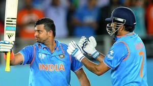 India's Suresh Raina waves his bat as his captain MS Dhoni watches after scoring a century while batting against Zimbabwe during their Cricket World Cup Pool B match.(AP) India's Suresh Raina waves his bat as his captain MS Dhoni watches after scoring a century while batting against Zimbabwe during their Cricket World Cup Pool B match.(AP)