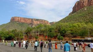 Employees queue to board a bus at foothill of Lord Venkateswara temple at Tirumala on the reopening day of the shrine, during the ongoing COVID-19 nationwide lockdown, in Tirupati.(PTI) Employees queue to board a bus at foothill of Lord Venkateswara temple at Tirumala on the reopening day of the shrine, during the ongoing COVID-19 nationwide lockdown, in Tirupati.(PTI)